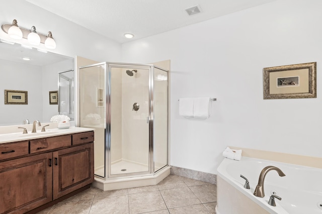 bathroom featuring vanity, plus walk in shower, and tile patterned flooring