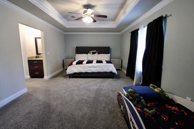 carpeted bedroom with ceiling fan, ensuite bathroom, a raised ceiling, and ornamental molding