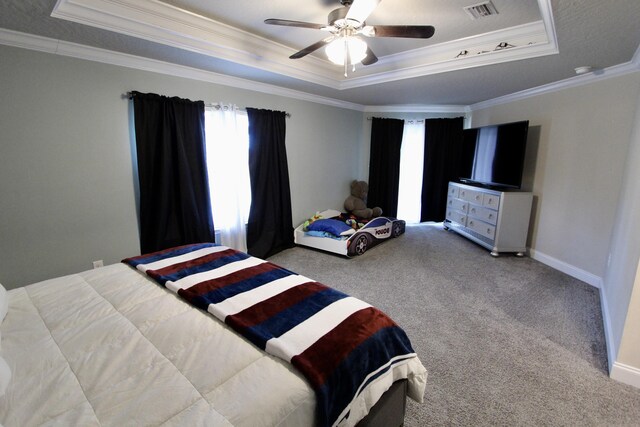 carpeted bedroom featuring a raised ceiling, ceiling fan, and ornamental molding