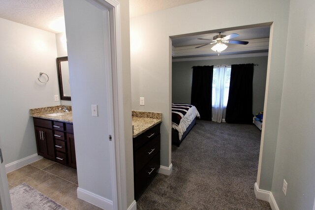 bathroom featuring crown molding, tile patterned floors, vanity, ceiling fan, and a textured ceiling