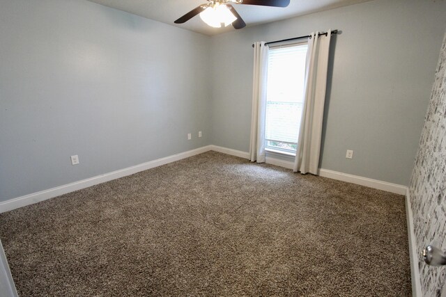 unfurnished room with ceiling fan and carpet