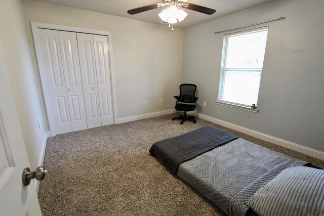 bedroom with a closet, ceiling fan, and carpet flooring