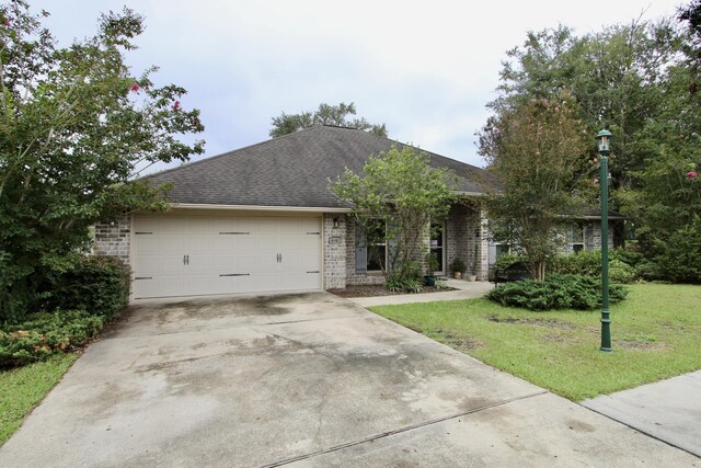 single story home with a garage and a front yard