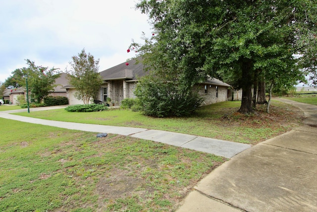 obstructed view of property with a front lawn