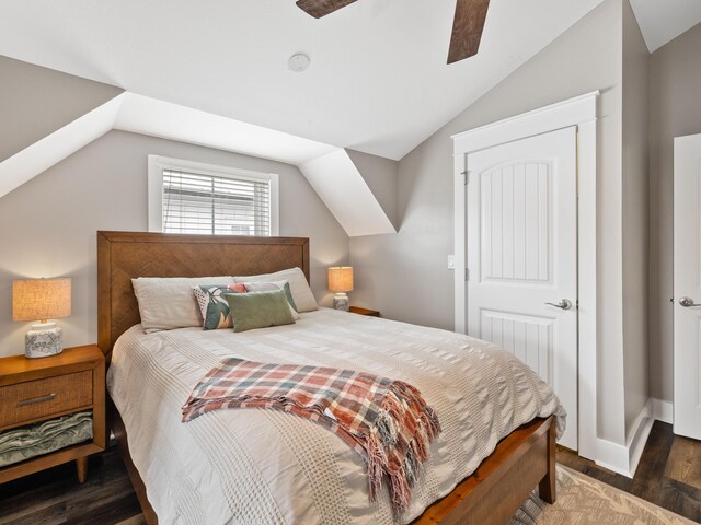 bedroom with ceiling fan, dark hardwood / wood-style floors, and vaulted ceiling