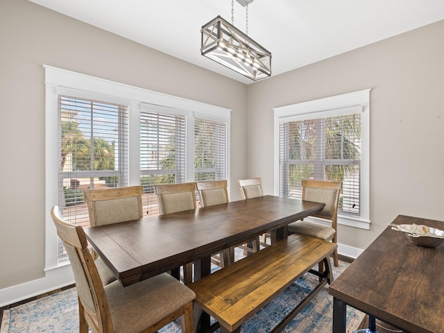 dining space with hardwood / wood-style flooring and a chandelier