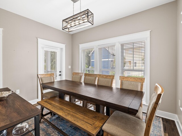 dining area featuring a chandelier and dark hardwood / wood-style flooring