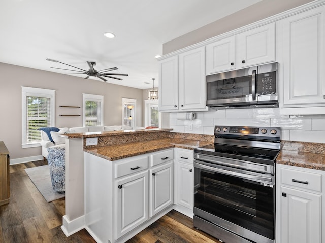 kitchen with ceiling fan, kitchen peninsula, appliances with stainless steel finishes, and white cabinets