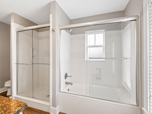 bathroom with separate shower and tub, hardwood / wood-style floors, and toilet