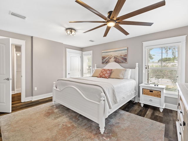 bedroom with ceiling fan and dark hardwood / wood-style flooring