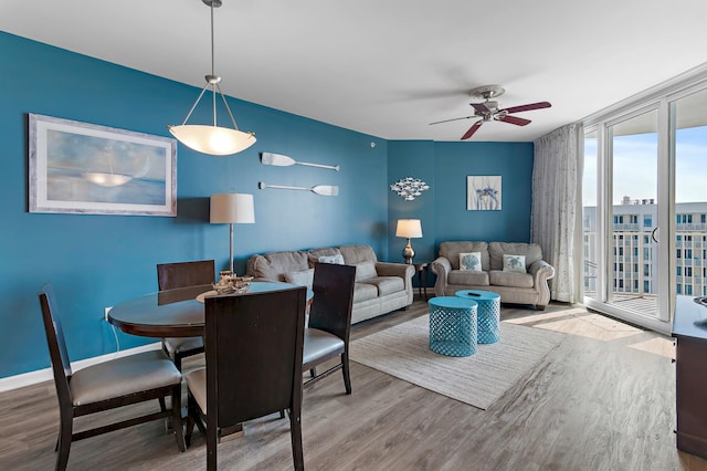 dining space featuring ceiling fan and hardwood / wood-style floors