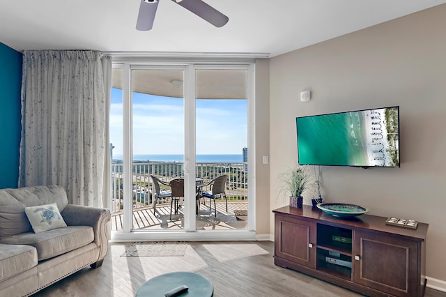 living room featuring ceiling fan and light hardwood / wood-style flooring