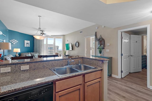 kitchen featuring light hardwood / wood-style floors, dishwasher, pendant lighting, stone countertops, and sink