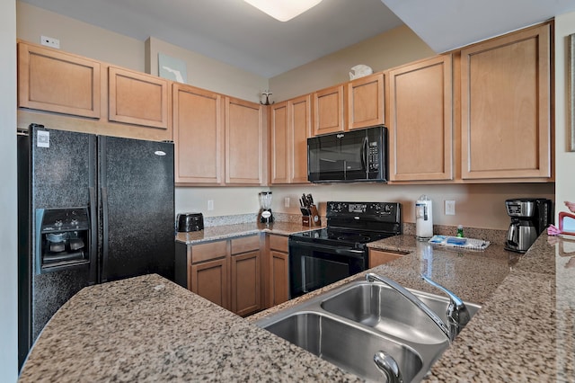 kitchen with black appliances and light stone counters