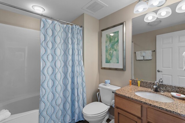 full bathroom with shower / bath combo, vanity, and toilet