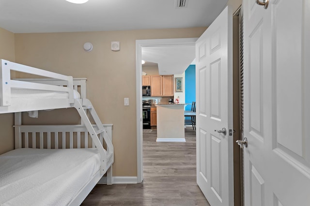 bedroom with light hardwood / wood-style flooring