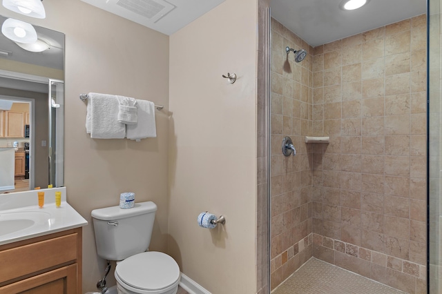 bathroom with walk in shower, vanity, and toilet