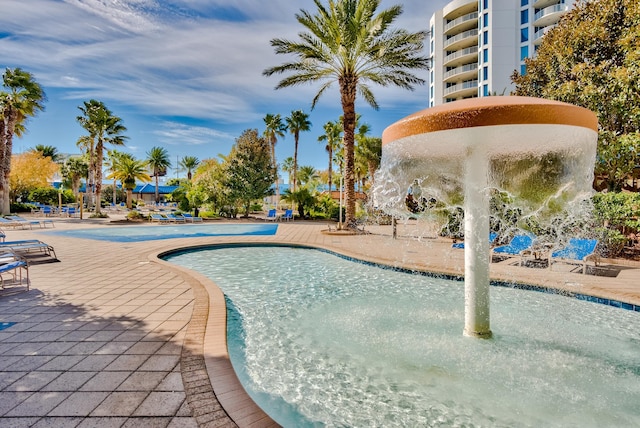 view of swimming pool with a patio area and pool water feature