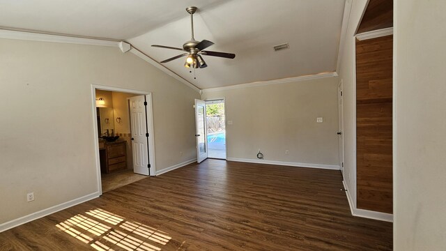 empty room featuring crown molding, vaulted ceiling, ceiling fan, and dark hardwood / wood-style floors