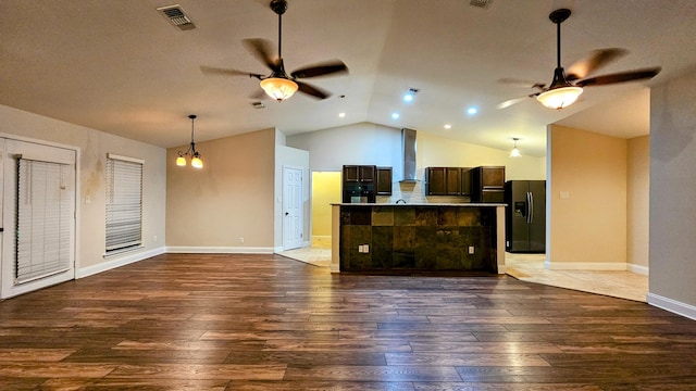 interior space featuring lofted ceiling, ceiling fan, and hardwood / wood-style floors