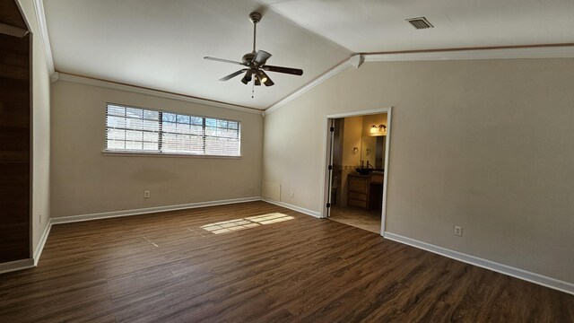 spare room featuring crown molding, vaulted ceiling, ceiling fan, and dark hardwood / wood-style floors