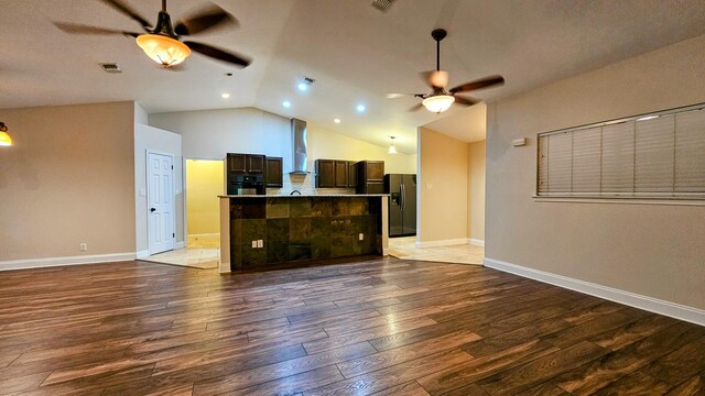 interior space featuring lofted ceiling, wood-type flooring, and ceiling fan