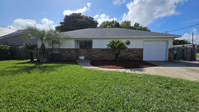 single story home with a garage and a front lawn