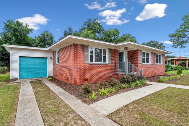 ranch-style home with a garage and a front lawn