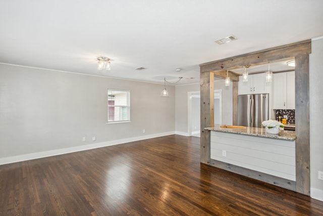 unfurnished living room with ornamental molding and dark hardwood / wood-style flooring