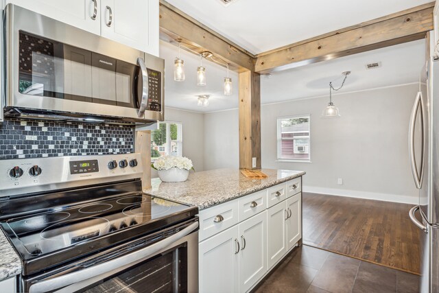 kitchen featuring appliances with stainless steel finishes, white cabinetry, a healthy amount of sunlight, and dark hardwood / wood-style floors