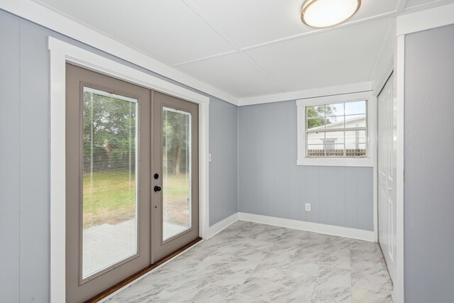 doorway to outside with wood walls and french doors