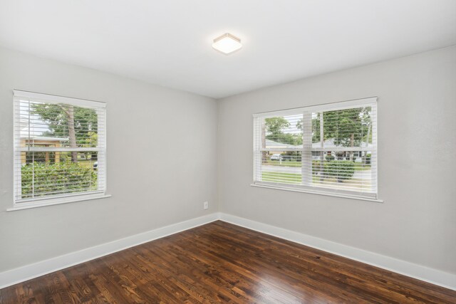 unfurnished room with wood-type flooring