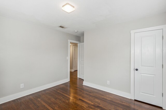 unfurnished bedroom featuring dark hardwood / wood-style flooring