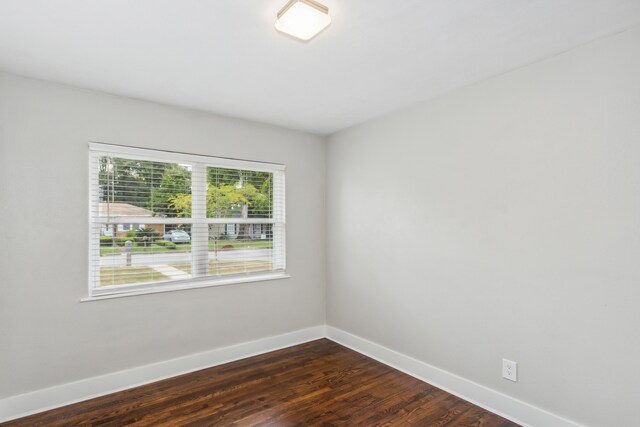 empty room featuring dark hardwood / wood-style flooring