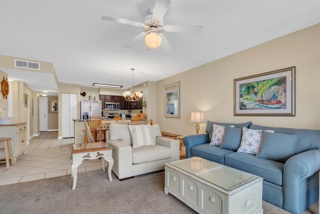 520 Santa Rosa Blvd Unit 301, Fort Walton Beach, FL 32548 - living room featuring light colored carpet, light tile patterned floors, ceiling fan with notable chandelier, baseboards, and visible vents