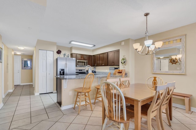520 Santa Rosa Blvd Unit 301, Fort Walton Beach, FL 32548 - dining room featuring baseboards, an inviting chandelier, and light tile patterned floors