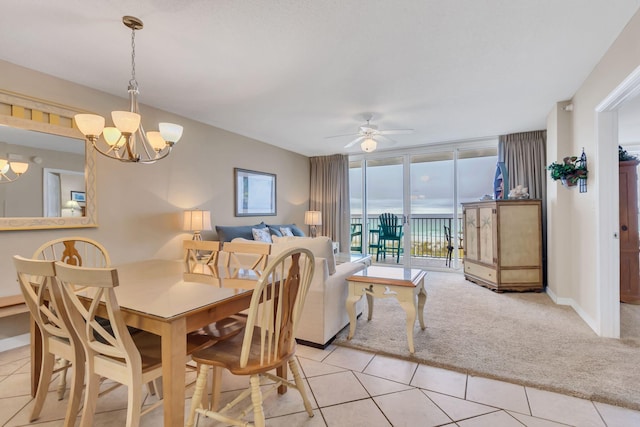 520 Santa Rosa Blvd Unit 301, Fort Walton Beach, FL 32548 - dining area with light tile patterned flooring, light carpet, a wall of windows, baseboards, and ceiling fan with notable chandelier