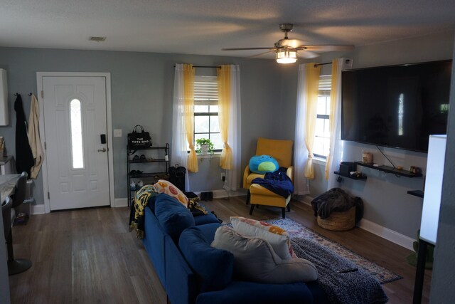 living room with ceiling fan and hardwood / wood-style flooring