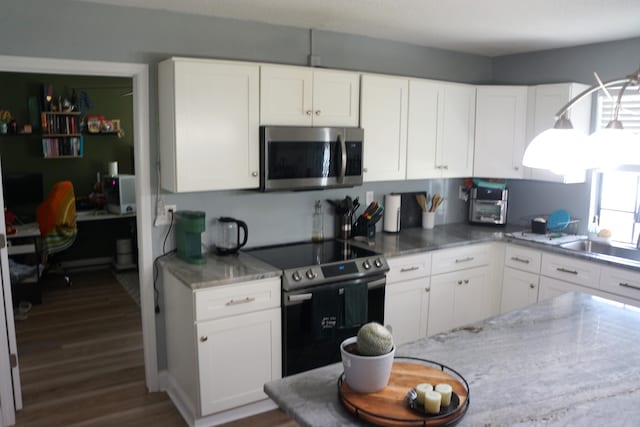 kitchen featuring sink, stone countertops, dark hardwood / wood-style flooring, stainless steel appliances, and white cabinets