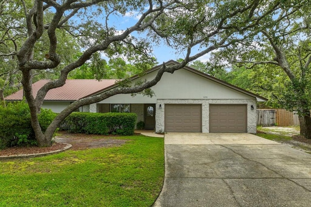 ranch-style house featuring a garage and a front lawn