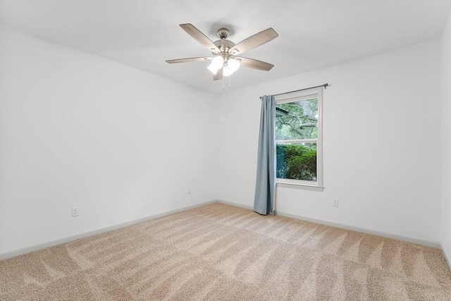 unfurnished room featuring ceiling fan and carpet flooring