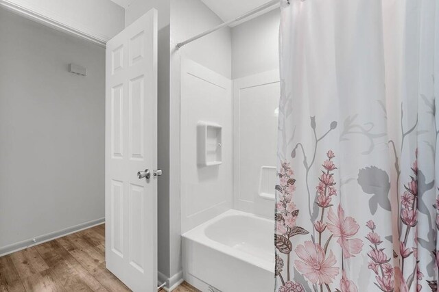 bathroom featuring shower / tub combo and hardwood / wood-style floors