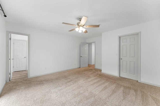 unfurnished bedroom with light carpet and ceiling fan