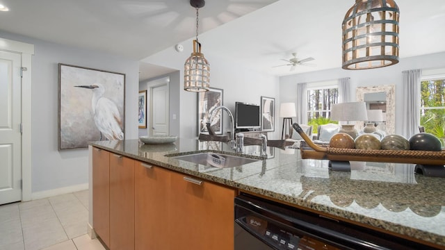 kitchen with sink, hanging light fixtures, dishwasher, stone counters, and a healthy amount of sunlight