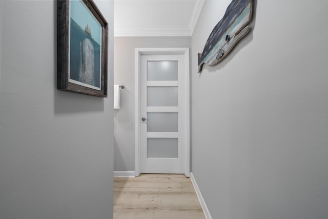 hall featuring light hardwood / wood-style floors and crown molding