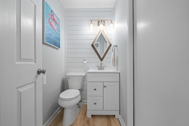 bathroom with vanity, wood-type flooring, and toilet