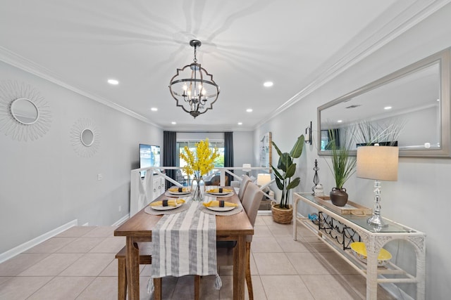 tiled dining room with a chandelier and ornamental molding