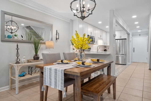 tiled dining room featuring a notable chandelier, ornamental molding, and sink