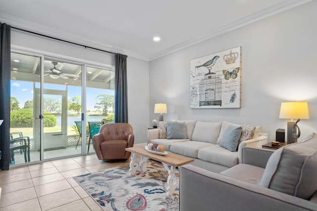 tiled living room featuring ceiling fan, a water view, and ornamental molding