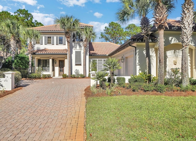 mediterranean / spanish home with a porch and a front lawn